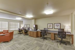 Kennewick apartment for rent - A well-lit office space with multiple desks and chairs.