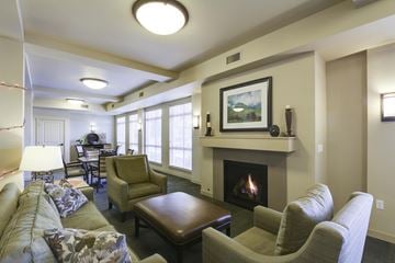 Kennewick apartment for rent - A living room with a fireplace and a painting on the wall.