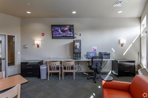 Walla Walla apartment for rent - A conference room with a television mounted on the wall and a desk with a computer.