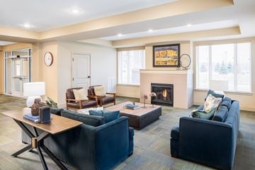Ramsey apartment for rent - A living room with a fireplace and a painting on the wall.