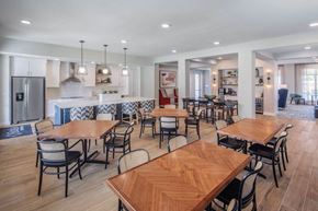 Lewisville apartment for rent - A modern dining room with wooden tables and chairs.
