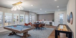 Lewisville apartment for rent - A room with a pool table and a foosball table.