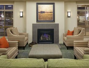 Spokane apartment for rent - A living room with a fireplace and striped chairs.