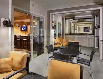 Spokane apartment for rent - A living room with a television and a dining table.