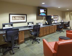 Spokane apartment for rent - A conference room with a long table, chairs, and a TV mounted on the wall.
