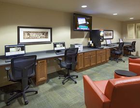 Spokane apartment for rent - A conference room with a long table and chairs, a television on the wall, and a framed picture.