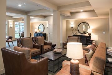Loveland apartment for rent - A living room with brown leather furniture and a glass coffee table.