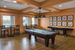 Loveland apartment for rent - A pool table in a room with a bar and chairs.