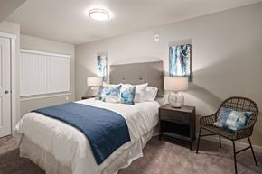 Arlington apartment for rent - A bedroom with a bed, chair, and nightstand.