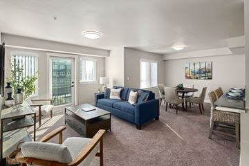 Arlington apartment for rent - A living room with a blue couch and a brown chair.