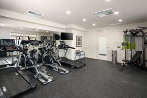 Bend apartment for rent - A spacious gym with treadmills, elliptical machines, and other exercise equipment.