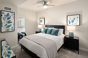 Bend apartment for rent - A bedroom with a large bed and two lamps.