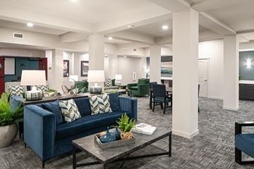 Bend apartment for rent - A living room with a blue couch and a coffee table.