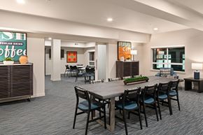 Burlington apartment for rent - A modern dining room with a large table and chairs.