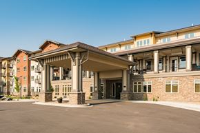 Aurora apartment for rent - A large building with a covered walkway in front.