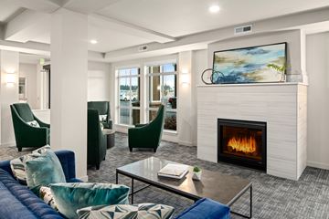 Spokane Valley apartment for rent - A modern living room with a fireplace and a painting on the wall.