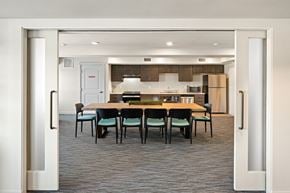 Spokane Valley apartment for rent - A kitchen with a table and chairs in the middle of the room.