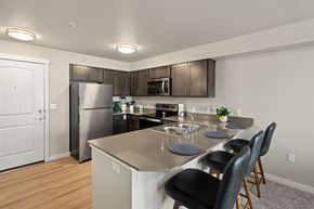 Pasco apartment for rent - A kitchen with a refrigerator, sink, and stove.