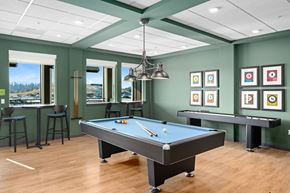 Pasco apartment for rent - A pool table is in the middle of a room with a bar and a view of the water.