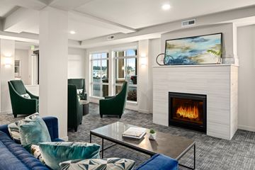 Richland apartment for rent - A modern living room with a fireplace and a painting on the wall.