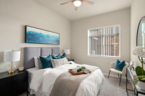 Pasco apartment for rent - A bedroom with a large bed and a painting on the wall.