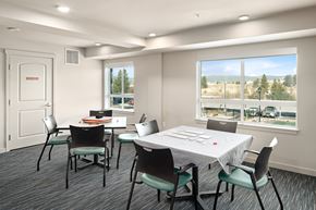 Pasco apartment for rent - A conference room with a table and chairs and a window overlooking a parking lot.