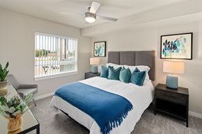 Nampa apartment for rent - A bedroom with a large bed and a ceiling fan.