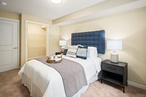 Puyallup apartment for rent - A bedroom with a bed, nightstand, and lamp.