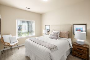 San Antonio apartment for rent - A bedroom with a bed, chair, and two lamps.