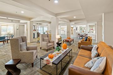 San Antonio apartment for rent - A living room with a brown couch and a table with pumpkins on it.