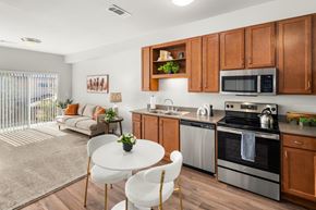 Austin apartment for rent - A modern kitchen with wooden cabinets and stainless steel appliances.