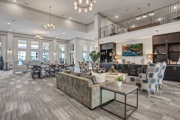 Cedar Park apartment for rent - A spacious living room with a grey sofa and a glass coffee table.