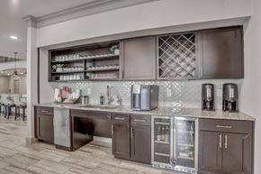 Cedar Park apartment for rent - A kitchen with brown cabinets and a marble countertop.