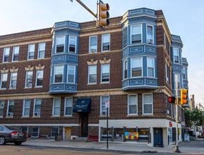 Philadelphia apartment for rent - a tall brick building with a traffic light in front of it