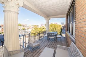 Philadelphia apartment for rent - a balcony with a table and chairs and a view of the city