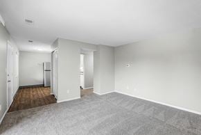Columbus apartment for rent - A spacious room with a carpeted floor and white walls.