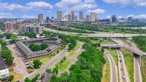 Columbus apartment for rent - A cityscape with a highway and buildings in the background.