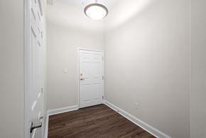 Halifax apartment for rent - a bedroom with white walls and a white door and a wooden floor