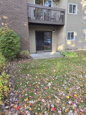 Bedford apartment for rent - a yard with leaves on the ground in front of a house