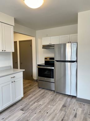 Halifax apartment for rent - A kitchen with a stainless steel refrigerator, oven, and cabinets.