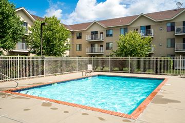 Burnsville apartment for rent - an apartment swimming pool with an apartment building in the background