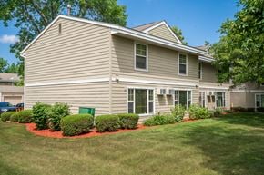 Burnsville townhouse for rent - a home with a lawn and landscaping in front of it