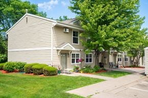 Burnsville townhouse for rent - a house with a lawn and trees in front of it