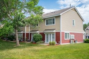 Burnsville townhouse for rent - a house with a lawn and a tree in front of it