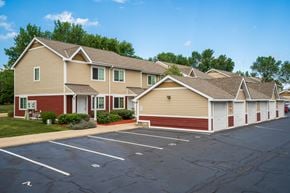Burnsville townhouse for rent - an empty parking lot in front of a row of houses
