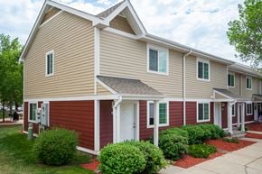 Burnsville townhouse for rent - a red and tan house with a sidewalk in front of it