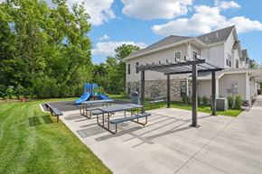 Medina townhouse for rent - A playground area with a slide and picnic table in front of a house  at Ironwood Townhomes in Medina, Minnesota.