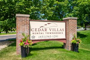 Eagan townhouse for rent - a sign villas rental condos in front of trees
