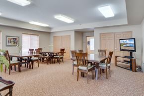 Eagan townhouse for rent - a dining room with tables and chairs and a television