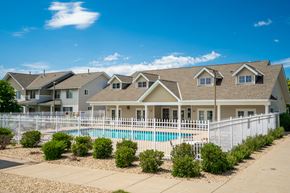 Eagan townhouse for rent - a house with a pool behind a white fence